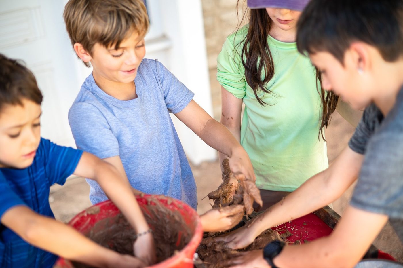 Campers mixing mud for adobe bricks
