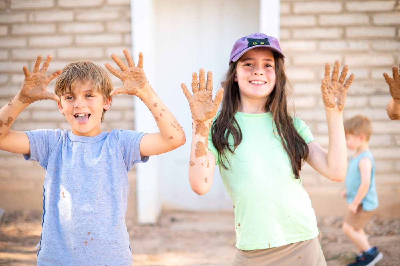 Campers peeking through the historic adobe wall
