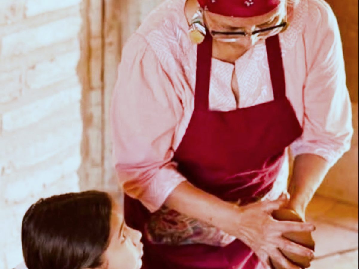 A costumed interpreter showing campers period food preparation